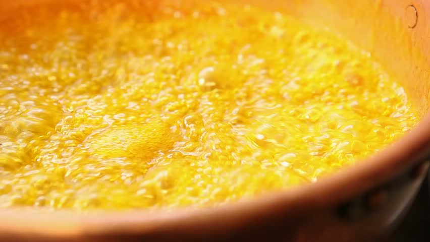 orange marmalade in a copper pot