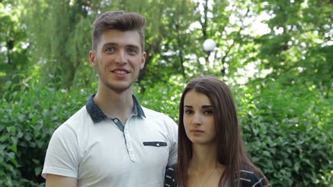 young couple smiling and talking to the camera in the Park