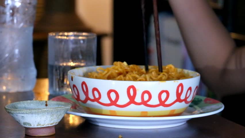 Little girl eating noodles