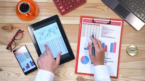 Businessman Using Tablet And Checks Start Up Statistics.  - Powered by Shutterstock - Get 15% off with code: PIKWIZARD15