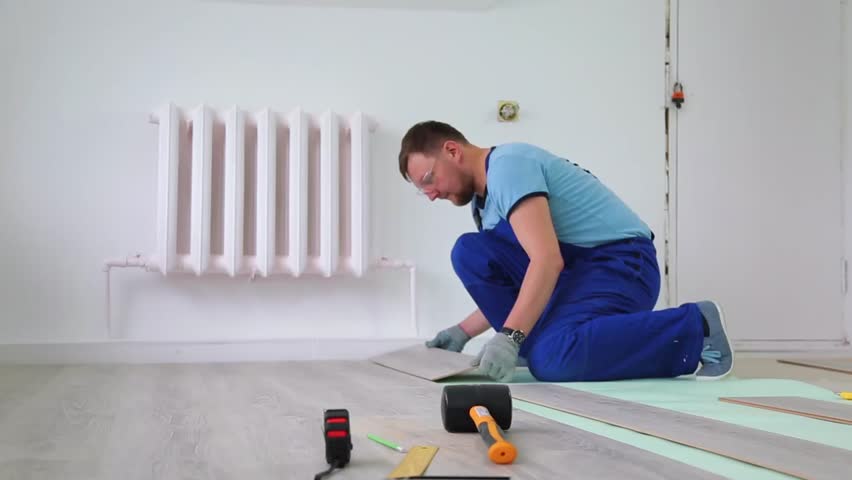 Man Laying floor Laminate indoors