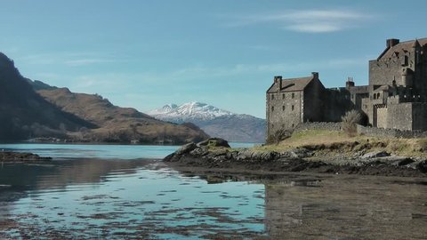 Eilean Donan Castle with loch and snow covered hills in the background
