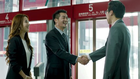 businessman meeting visiting client at elevator hall