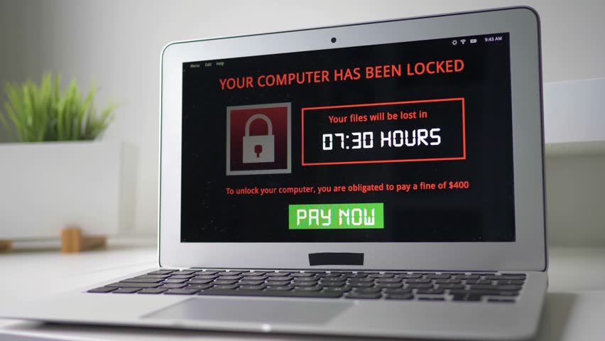 Laptop computer being infected by a ransomware virus that is asking for money to retrieve the encrypted files. Royalty-Free Stock Footage #27677479