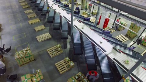 TVER - MAY 17, 2017: People work near conveyor with orders packages in Ozon company warehouse. Aerial view