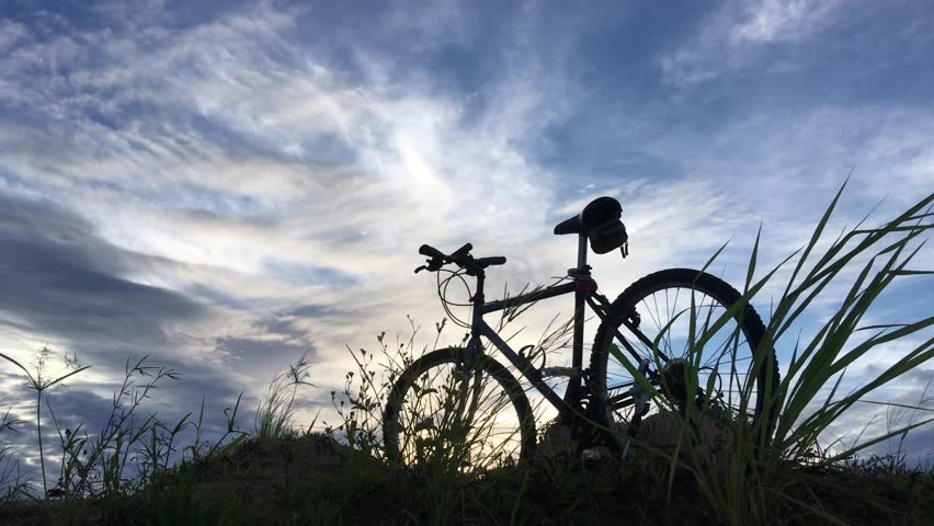 Silhouette bicycle parking and cloudscape.