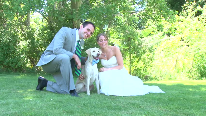 Model released bride and groom with their dog, posing for portraits on their