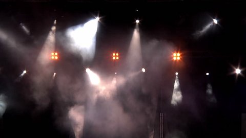 lighting in the smoke at a rock concert