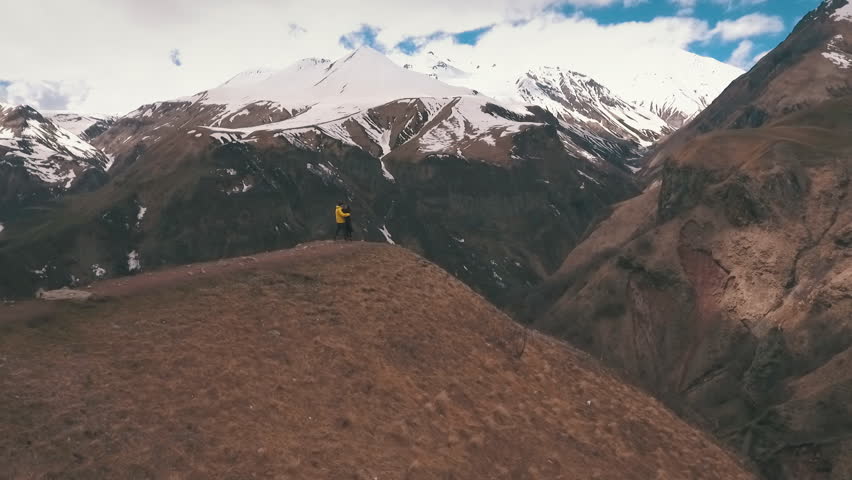 couple embraces on the edge of the mountain