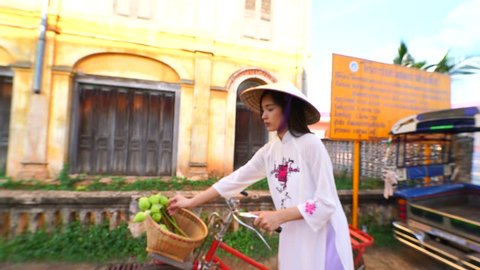 beautiful woman with Vietnam culture traditional dress, Ao dai and riding bicycle,4k