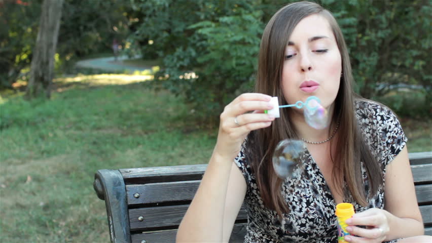 girl blowing soap bubbles 