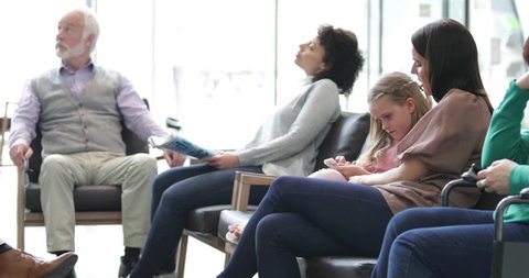 Patients waiting in a crowded hospital waiting room