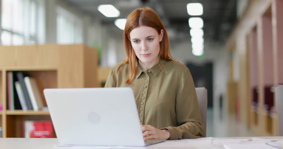 Female entrepreneur working on laptop | Shutterstock HD Video #27705775
