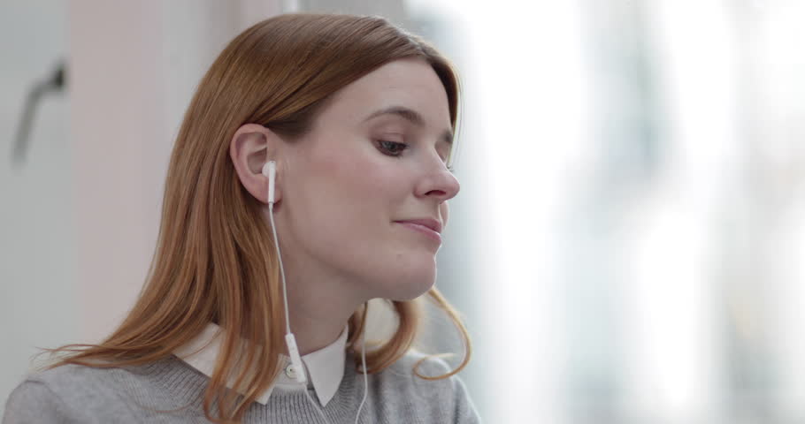 Female listening to audio with headphones | Shutterstock HD Video #27706312
