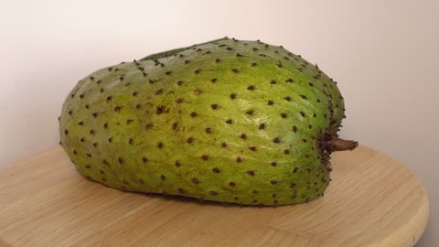 Soursop, Annona muricata L with slice rotate on wooden cutting board