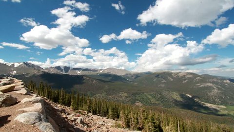 A 180 degree motion time-lapse from the peak of Rocky Mountain National Park as big puffy cumulus clouds move overhead
