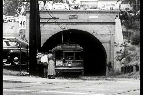 1950s: People waiting at a subway stop and examples of different modes of transport designed for in and around the cities in America in 1950.
