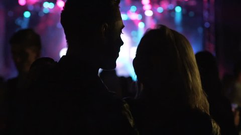 Night club atmosphere, loving couple dancing and laughing at music festival