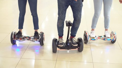 Young hipsters move around the shopping center on a hyroscooter