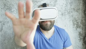business, technologies,  VR, people and lifestyle concept - Bearded man uses VR-headset display with headphones for virtual reality game. 4K, 3840, 2160