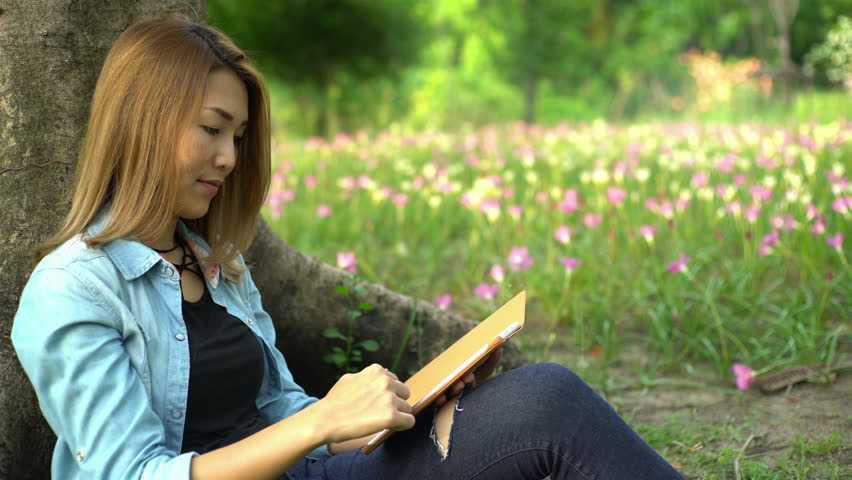 Beautiful girls use the tablet to talk and buy online. Lifestyle concept.