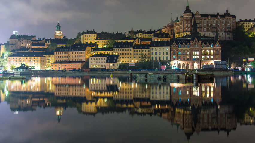 Stockholm city architecture buildings at night 4K Time Lapse. Sodermalm cityscape district, reflections in the water