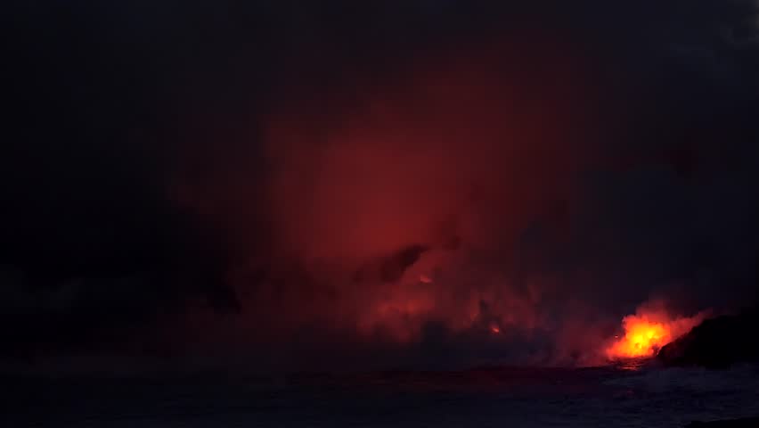 Lava flows into the ocean at night. Kilauea Volcano, Hawaii Big Island, USA.