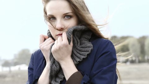 Young woman on the beach on a windy day; Full HD Photo JPEG
