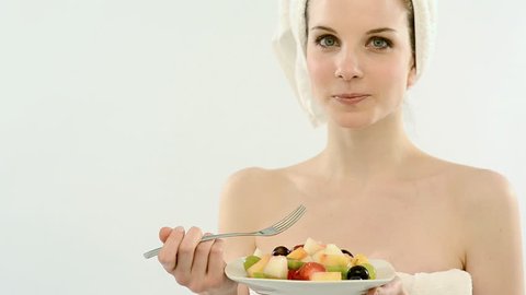 Beautiful young woman in towel eating fruit salad; Full HD Photo JPEG
