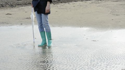 Young woman on the beach on a rainy a day; Full HD Photo JPEG
