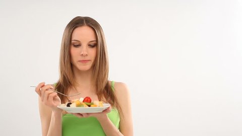Beautiful young woman eating fruit salad; Full HD Photo JPEG
