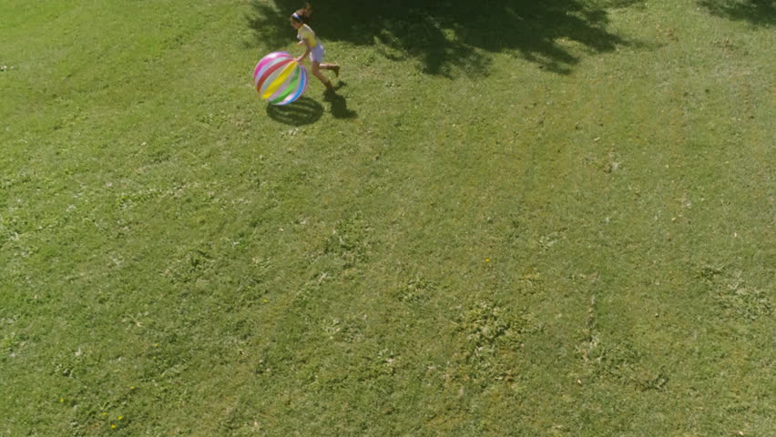 Two little girls playing with jumbo ball at the farm