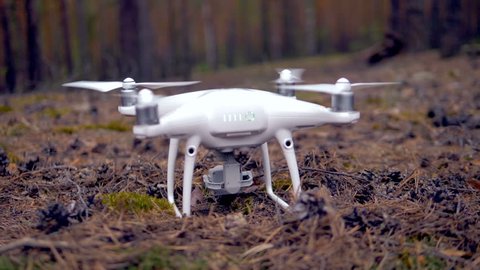 A drone flying in the forest, slow motion.
