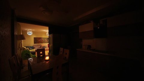 Turning on and off light in kitchen with dinner table in apartment