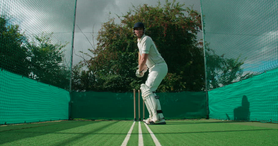 A cricket batsman plays a shot in the nets. Royalty-Free Stock Footage #27750058