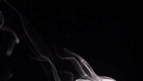 Smoke isolated on black background. White smoke raising up over black. Steaming cup of hot tea or coffee, food or drink. 4K UHD video 3840X2160