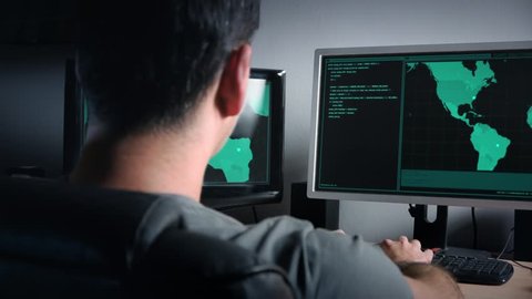 Hacker working in dark room