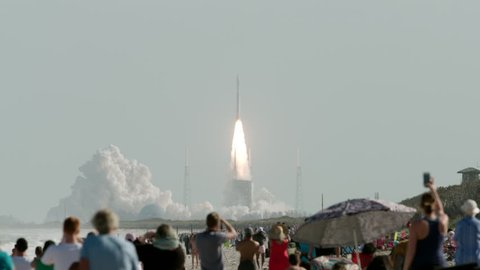 Rocket launch in Florida with people in the foreground watching lift-off - super slow motion