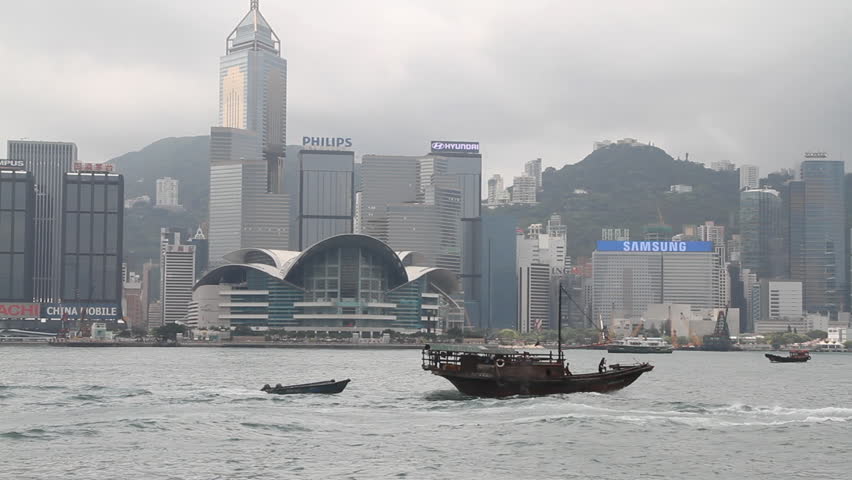 HONG KONG - APRIL 13: Fishing boat across Hong Kong Victoria harbor on April 13,