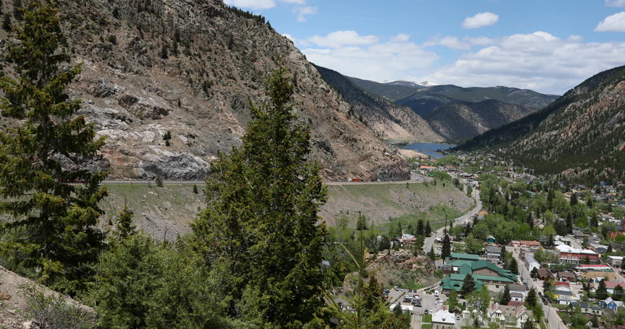 GEORGETOWN, COLORADO - 1 JUN 2017: Georgetown Colorado from mountain overhead valley highway pan. Historical summer tourist center.  Historical business, buildings and homes are in town.