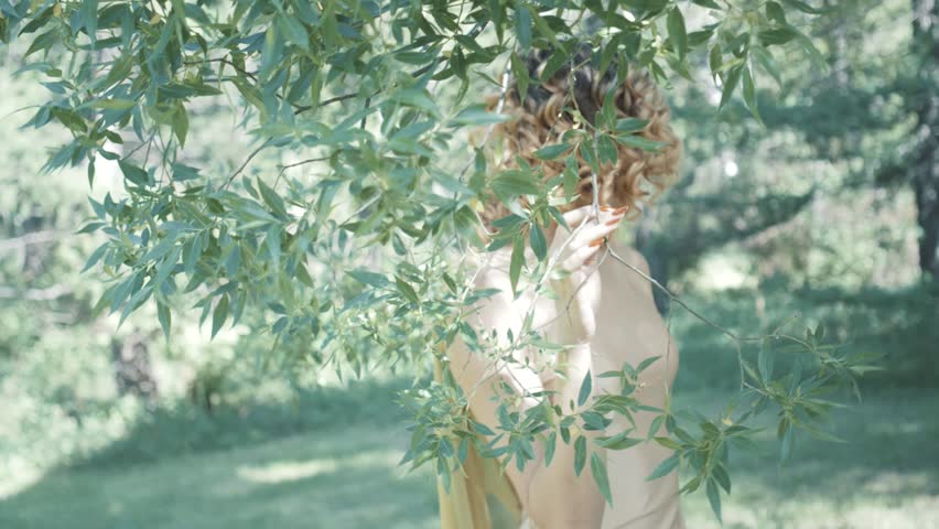 Young beautiful model posing in forest. Photo session. Fashion. Slow motion
