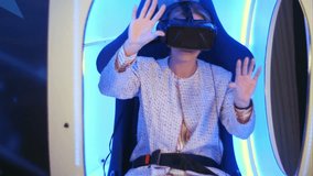 Young woman in virtual reality headset preparing for vr session