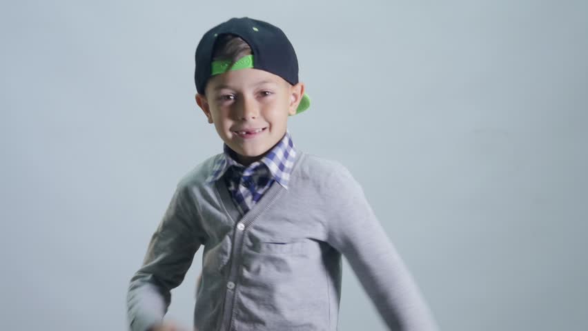 A boy with a toothless smile dances a break with his hands. | Shutterstock HD Video #27778687