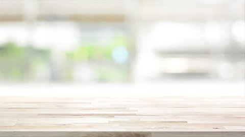 Wood table top on blur kitchen window background - can be used for display your products (or foods)