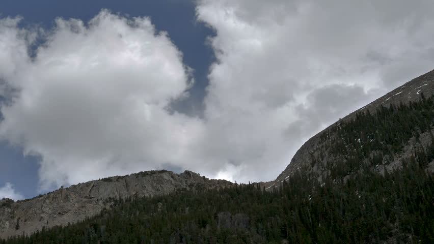 Time Lapse-Storm clouds build and boil over rocky mountain top in the Rocky Mountains of Colorado