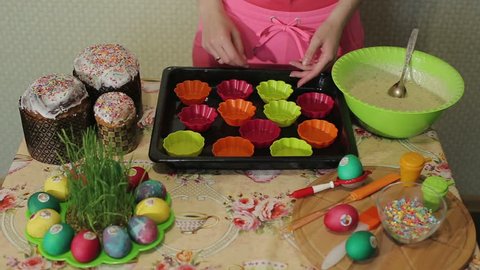 Girl pours batter into cupcake molds