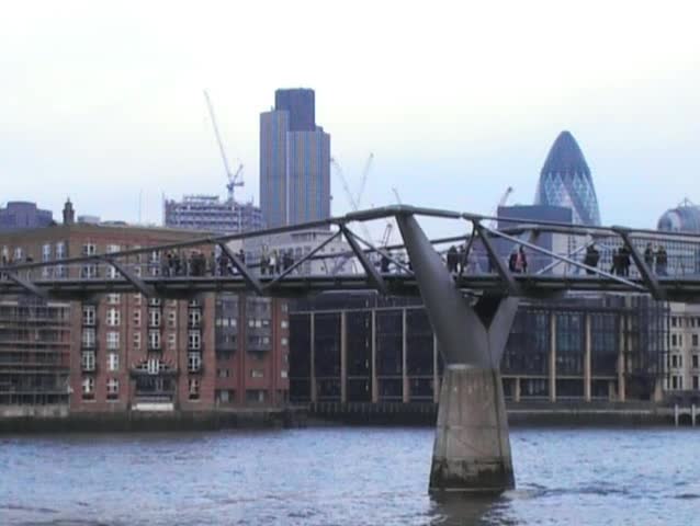 people walking across pedestrian Millennium bridge London