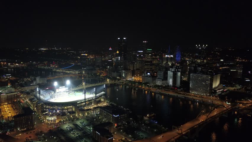 Pittsburgh Pirates Baseball PNC Park Reveal with lights on lit up with city in background night aerial 4K