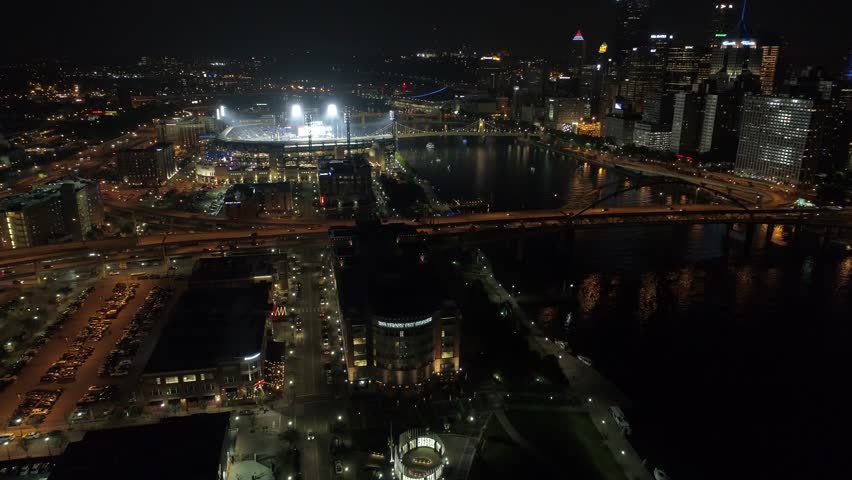 Pittsburgh Pirates Baseball PNC Park Reveal with lights on lit up with city in background night aerial 4K