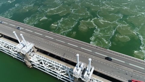Aerial camera panning down over Oosterscheldekering is largest of the 13 ambitious Delta Works series of dams and storm surge barriers designed to protect the Netherlands from flooding from North Sea